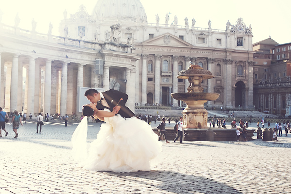 the happy couple kissing in Roman square - wedding photo by top Rome based destination wedding photographer Rochelle Cheever, Rome Weddings Photography
